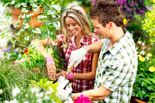 Volunteers sorting garden waste into labelled containers