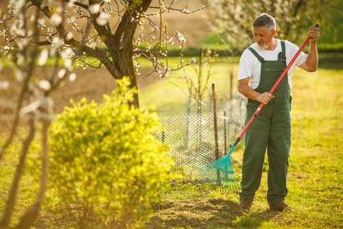 Gardeners trimming hedges safely